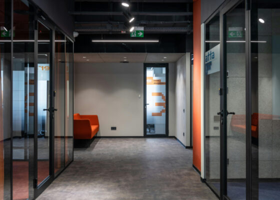 Corridor with glass partitioned offices on either side
