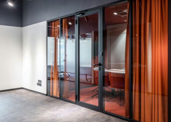 Glass and timber doors with orange curtains